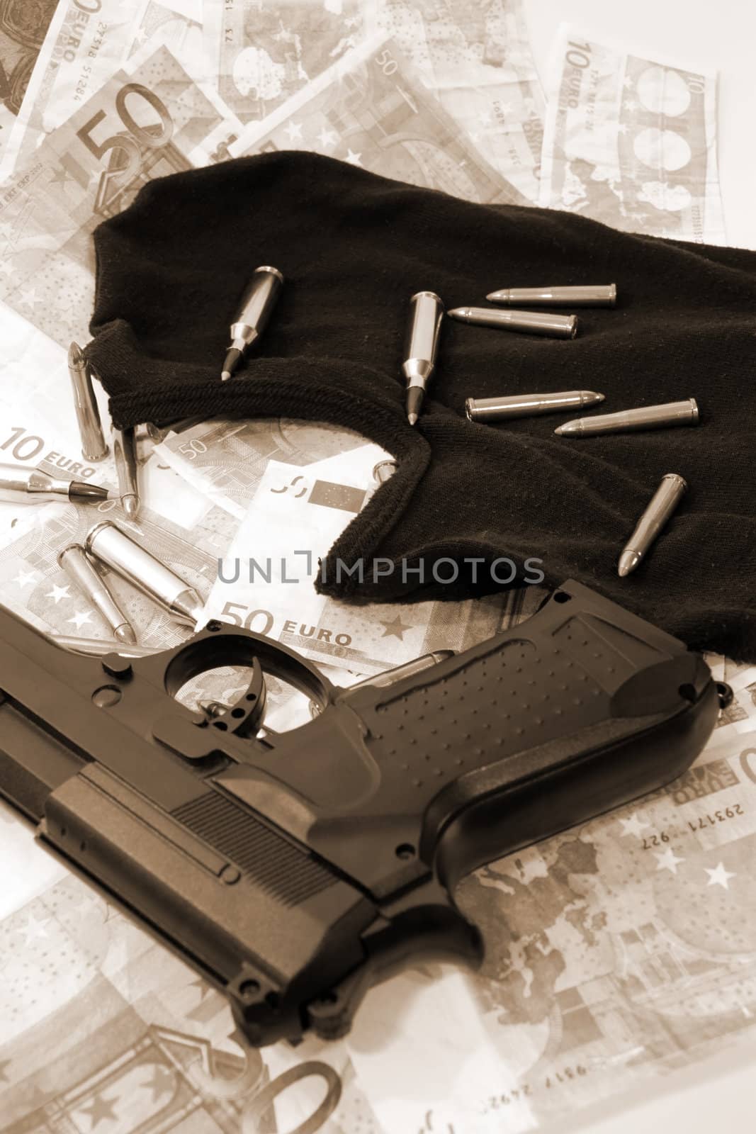 balaclava money a gun and bullets showing concept of a robber or terrorist activity