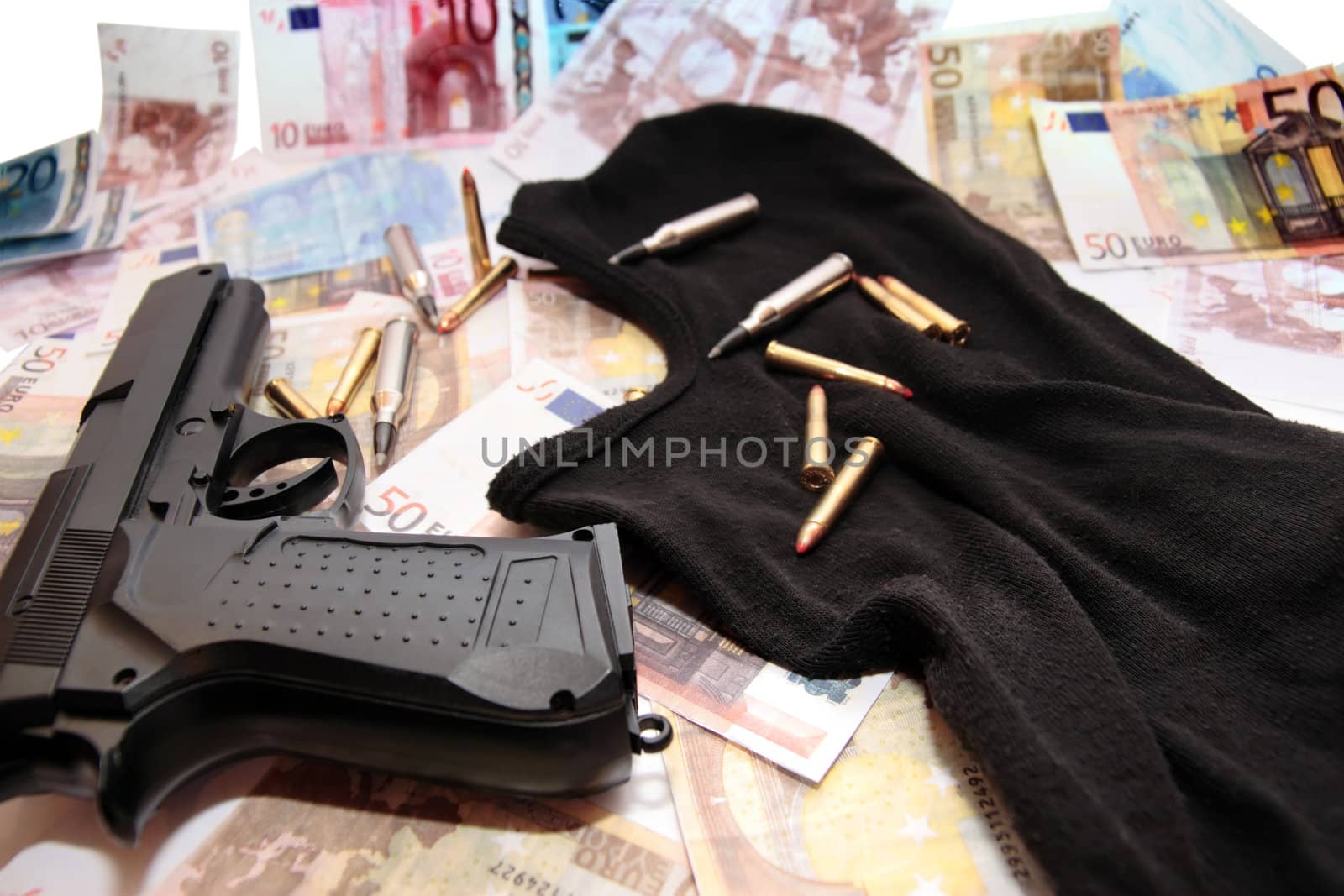 balaclava money gun and bullets showing a concept of a robbers or terrorists activity