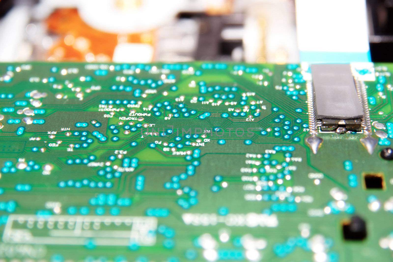 close up of a green and blue printed circuit board