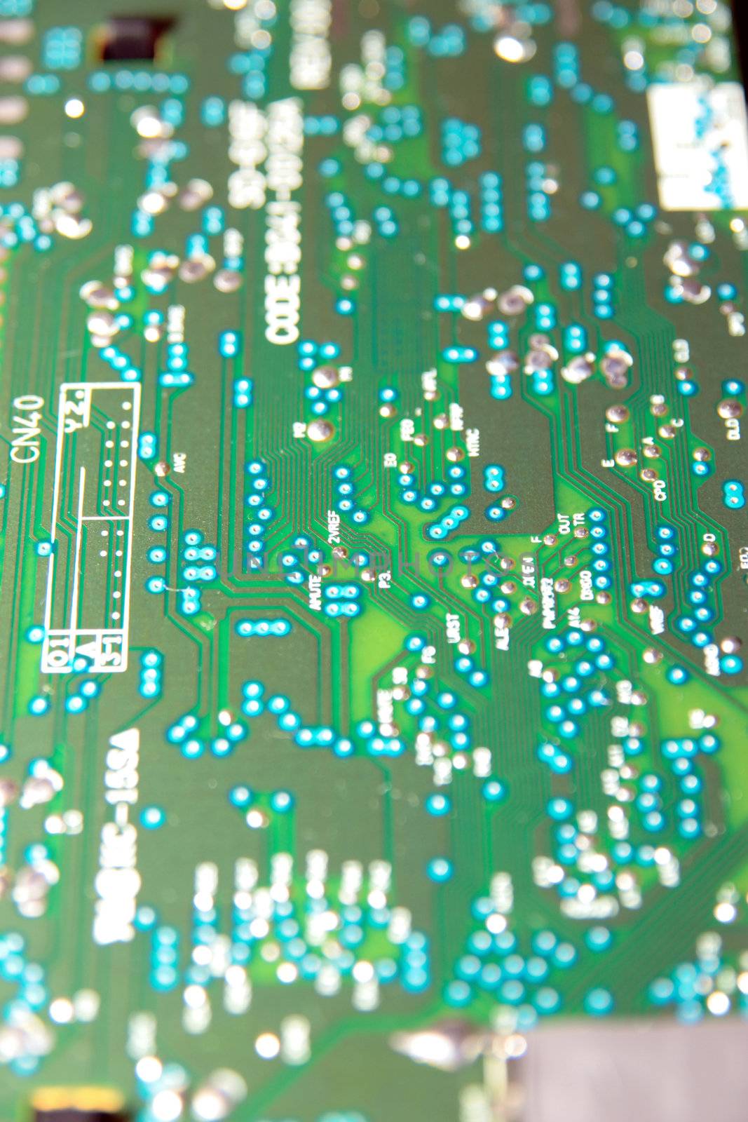close up of a green and blue printed circuit board