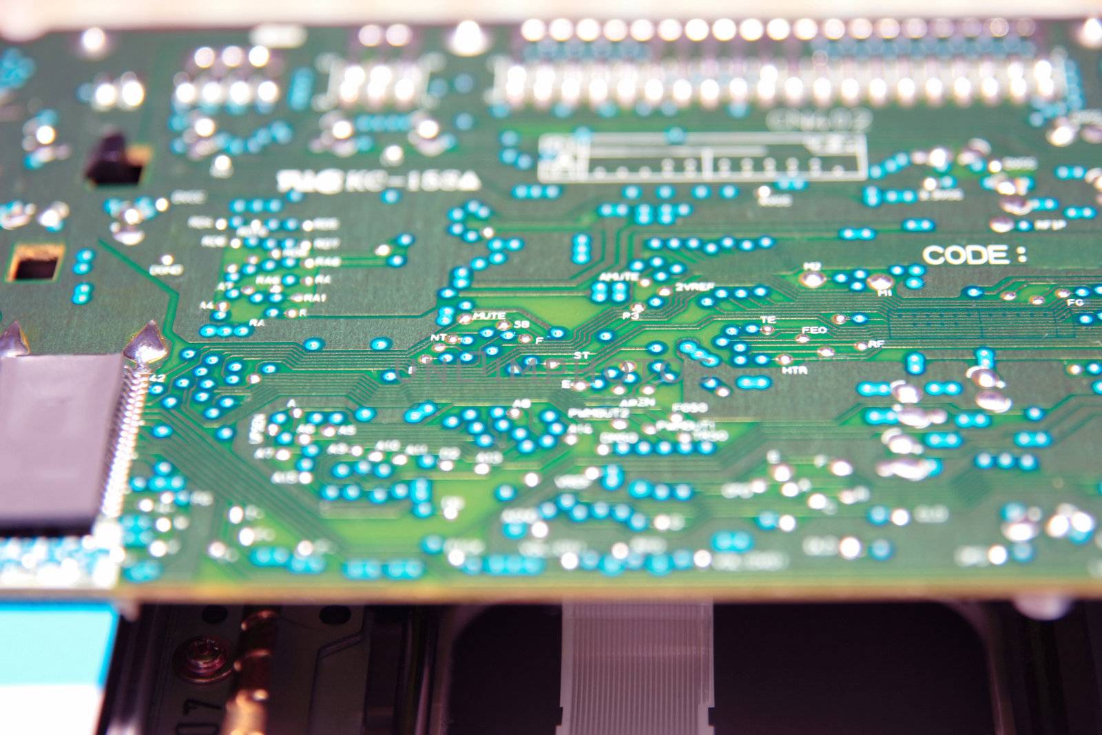close up of a green and blue printed circuit board