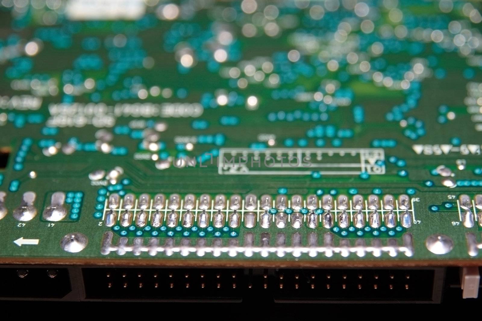 close up of a green and blue printed circuit board
