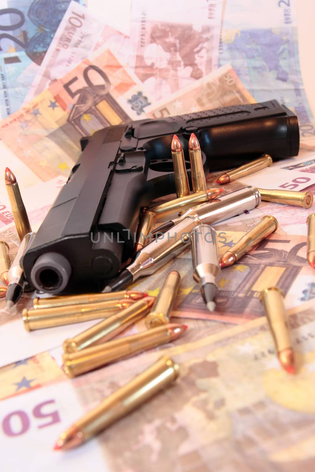 gun bullets and money showing a dangerous side to life