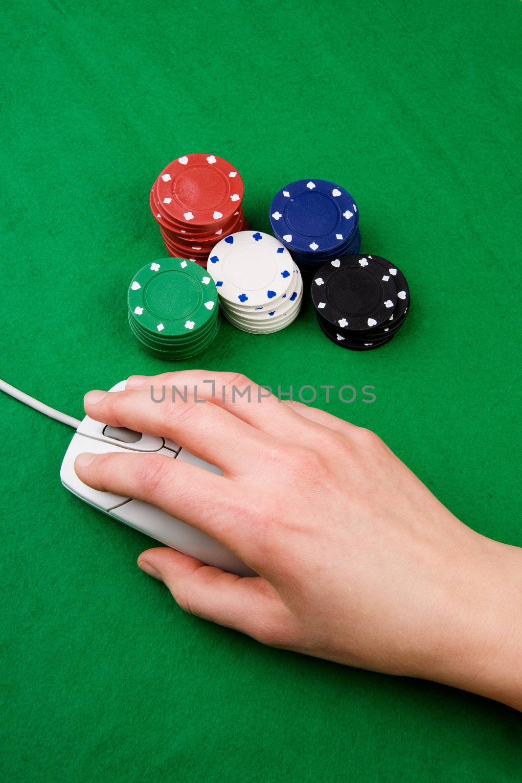 An online gambling concept - computer mouse, hand and casino chips