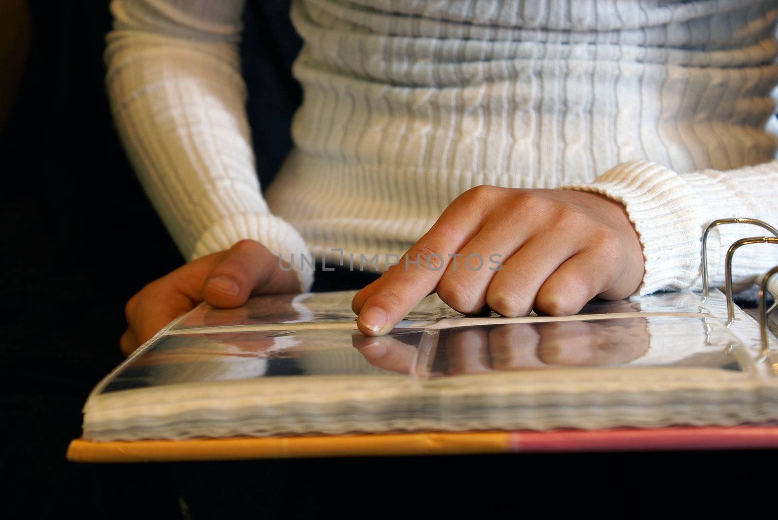 A woman looking though her photo album.