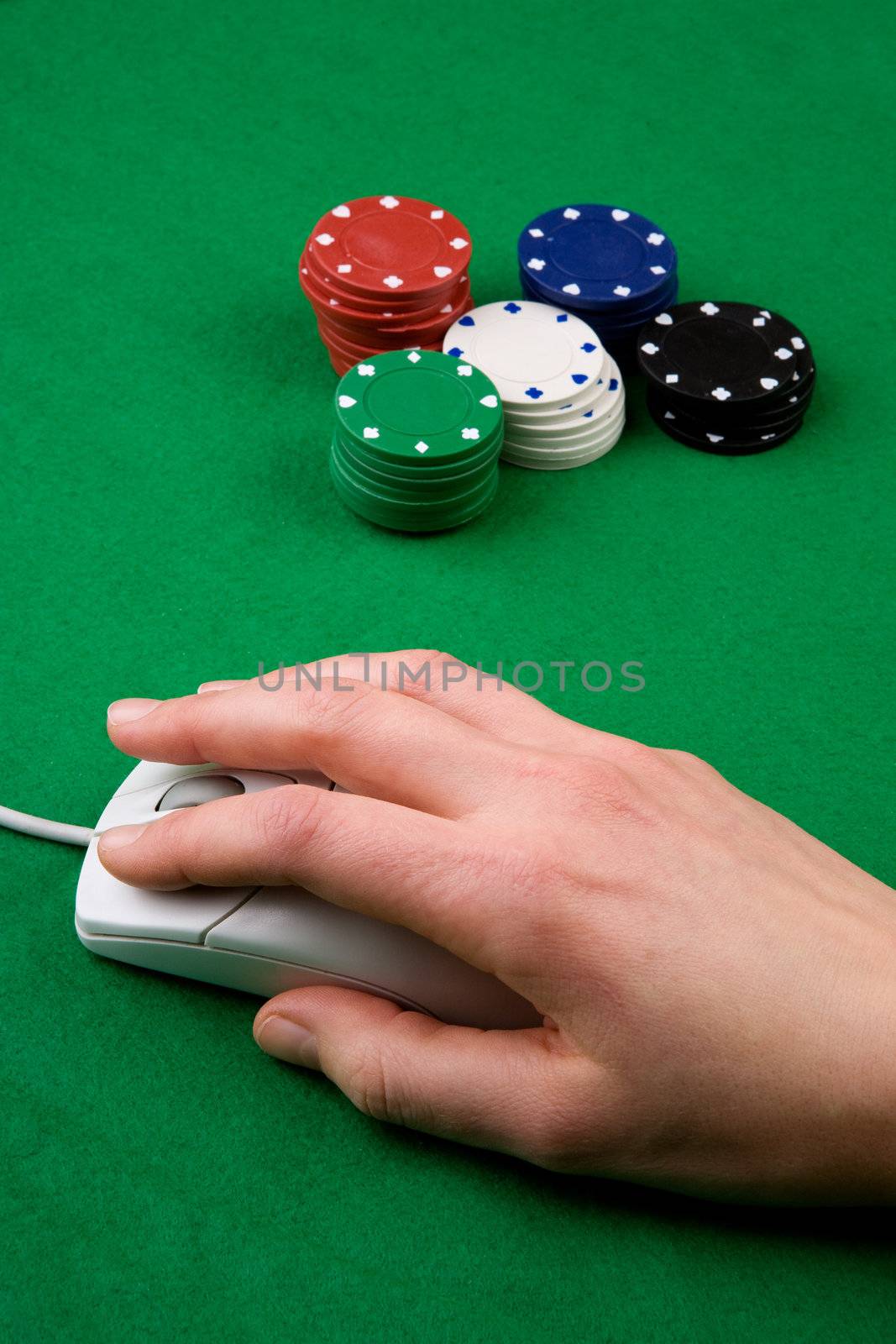 An online gambling concept - computer mouse, hand and casino chips