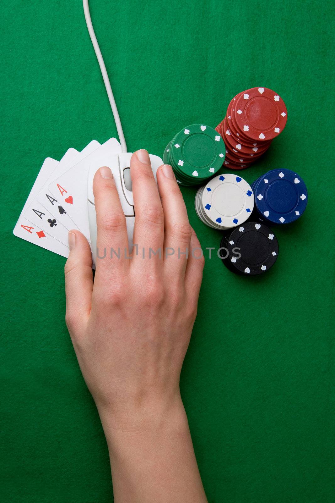 An online gambling concept - computer mouse, hand and casino chips