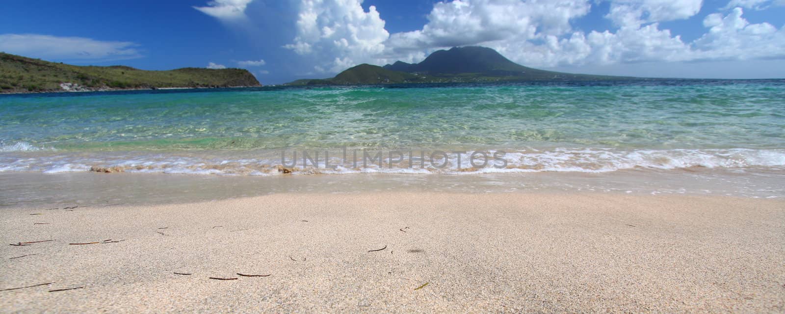 Waves wash ashore at Majors Bay Beach on the Caribbean island of Saint Kitts.