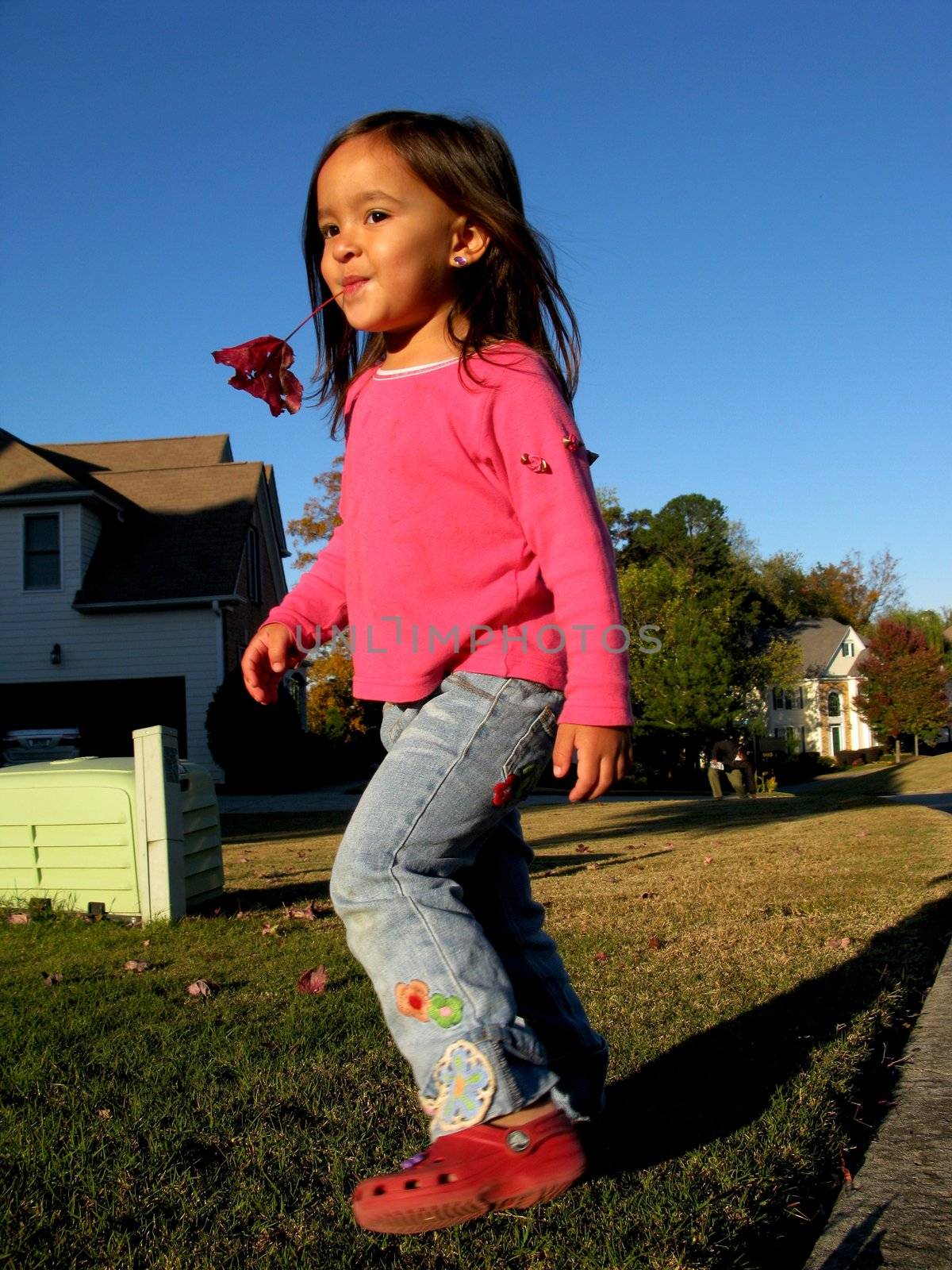 Little girl playing in the suburban neighborhood