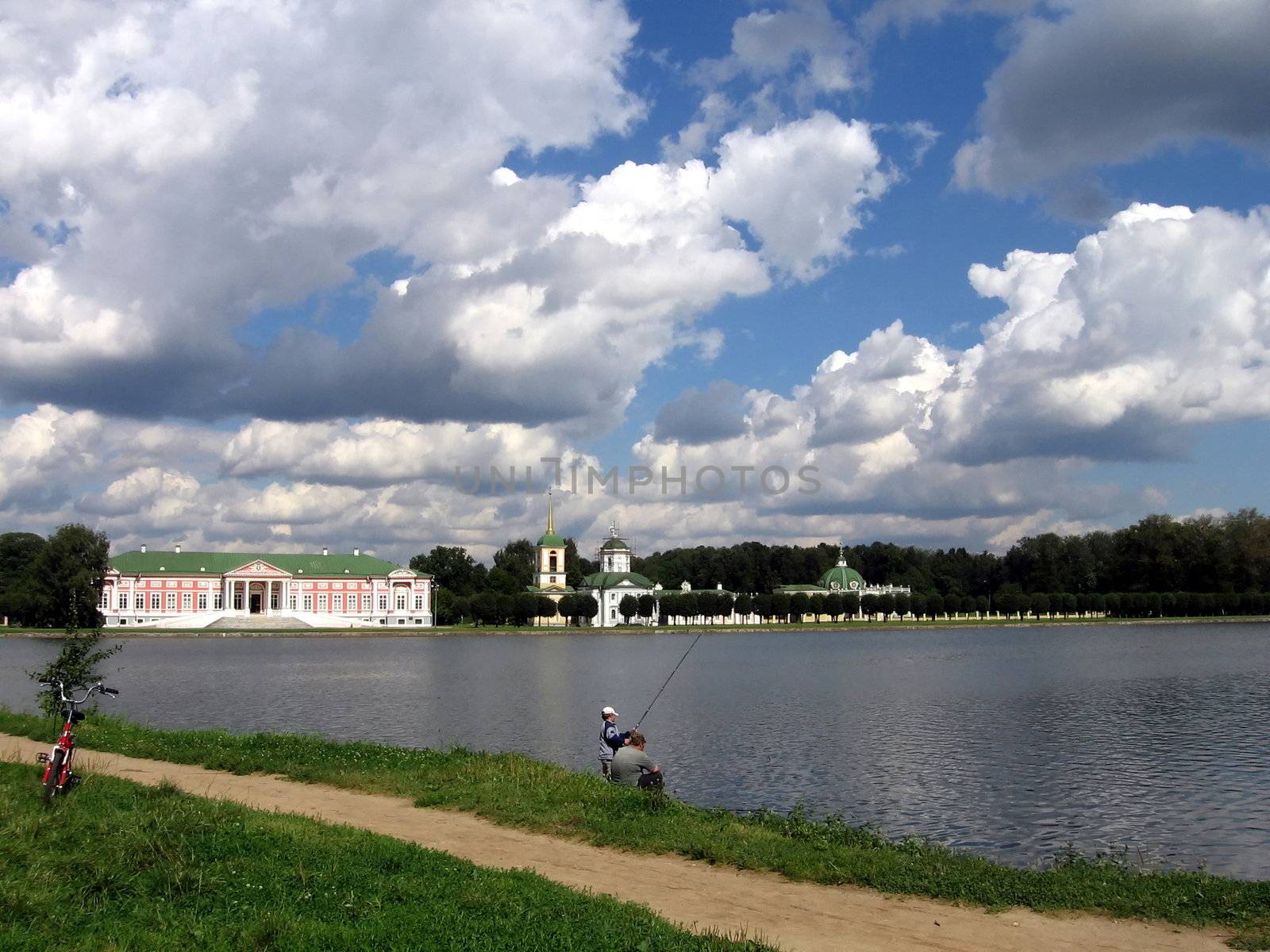 Fishing at the lake near historical architectures