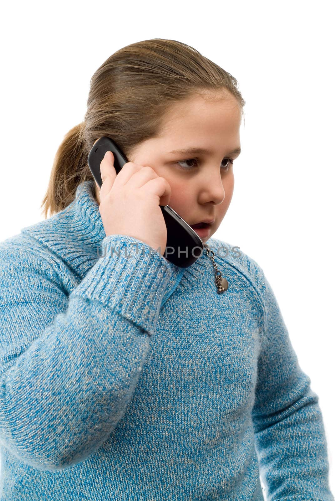 A young girl having a serious conversation on a cell phone, isolated against a white background