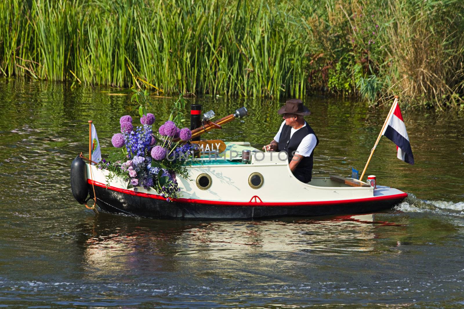 VLAARDINGEN, THE NETHERLANDS - JULI 2010: Beautiful flower boats in the unique annual Westland Floating Parade Juli 30, 2010, Vlaardingen, the Netherlands.

