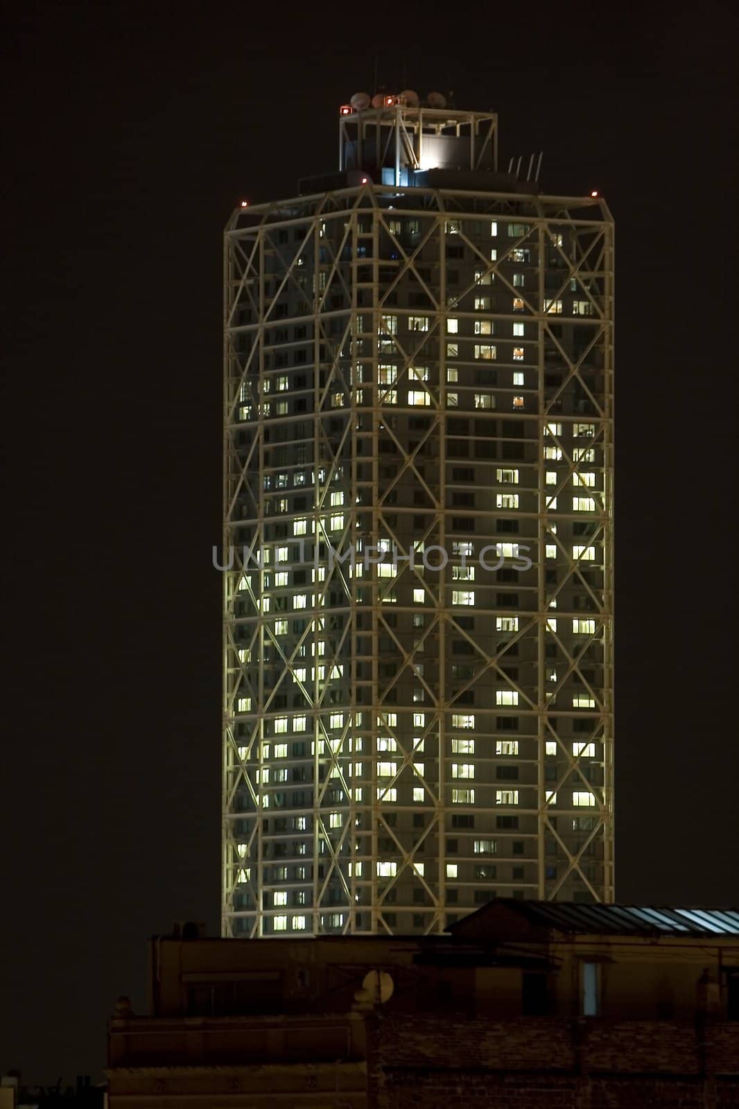 a skycraper building construction at work hours at night