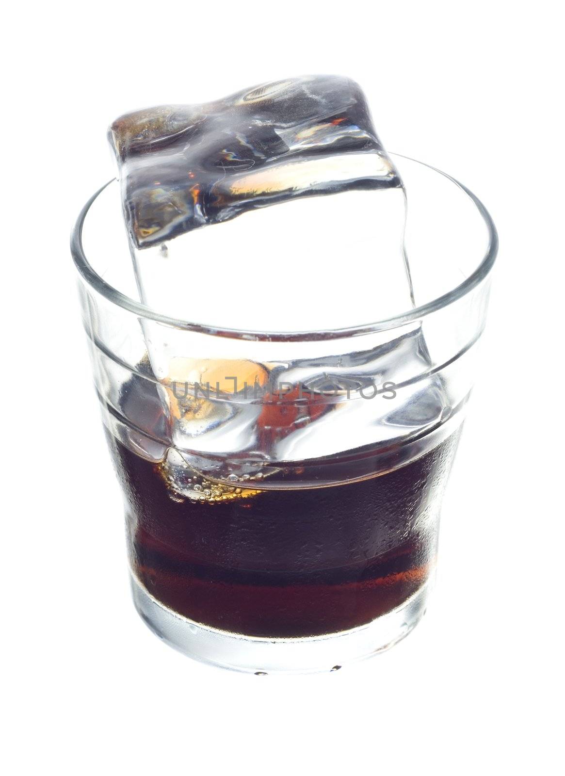 cola soft drink in a glass full of ice cubes