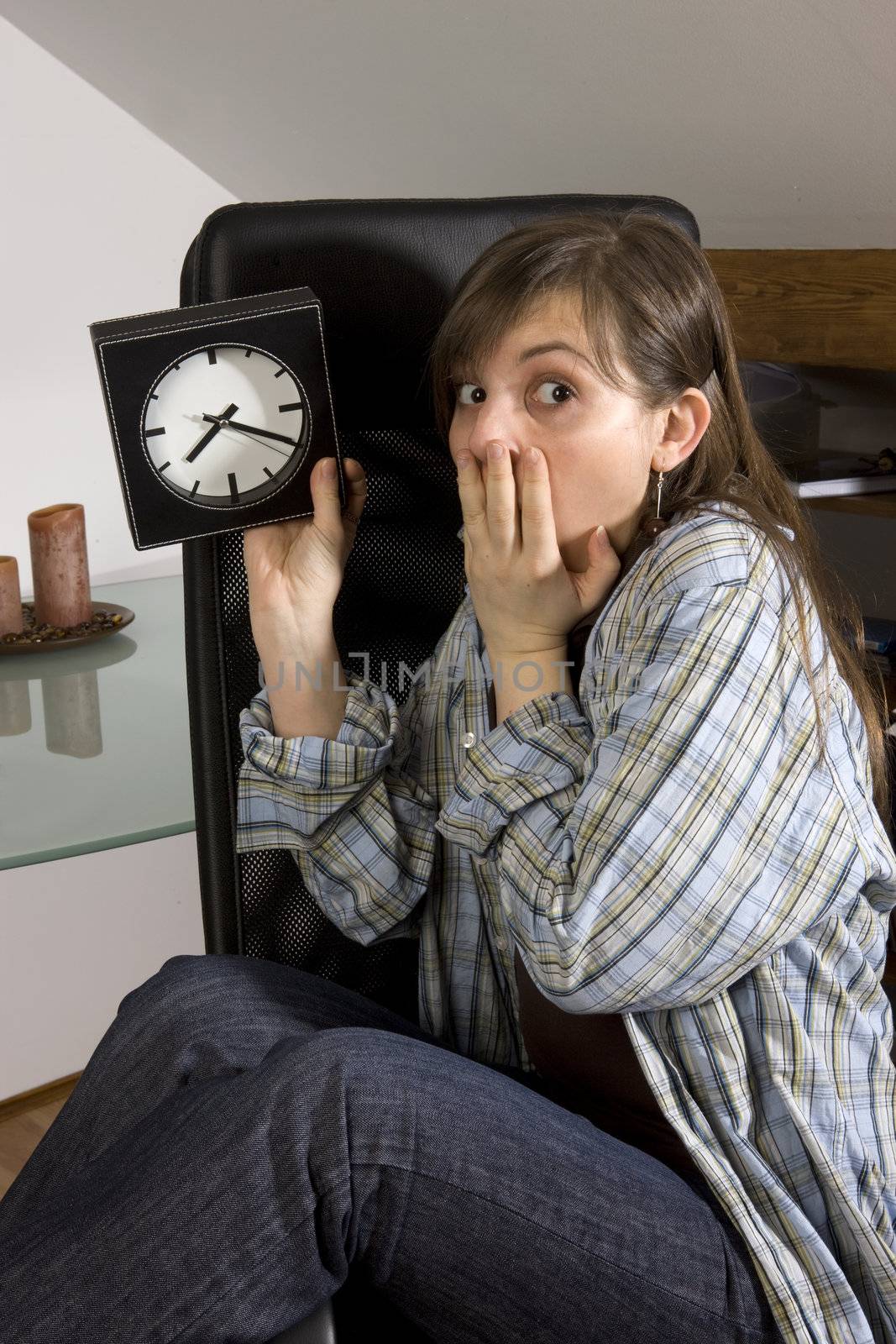 young woman looks on watch