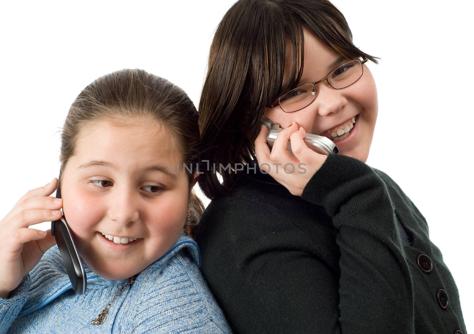 Two girls talking on cell phones, isolated against a white background