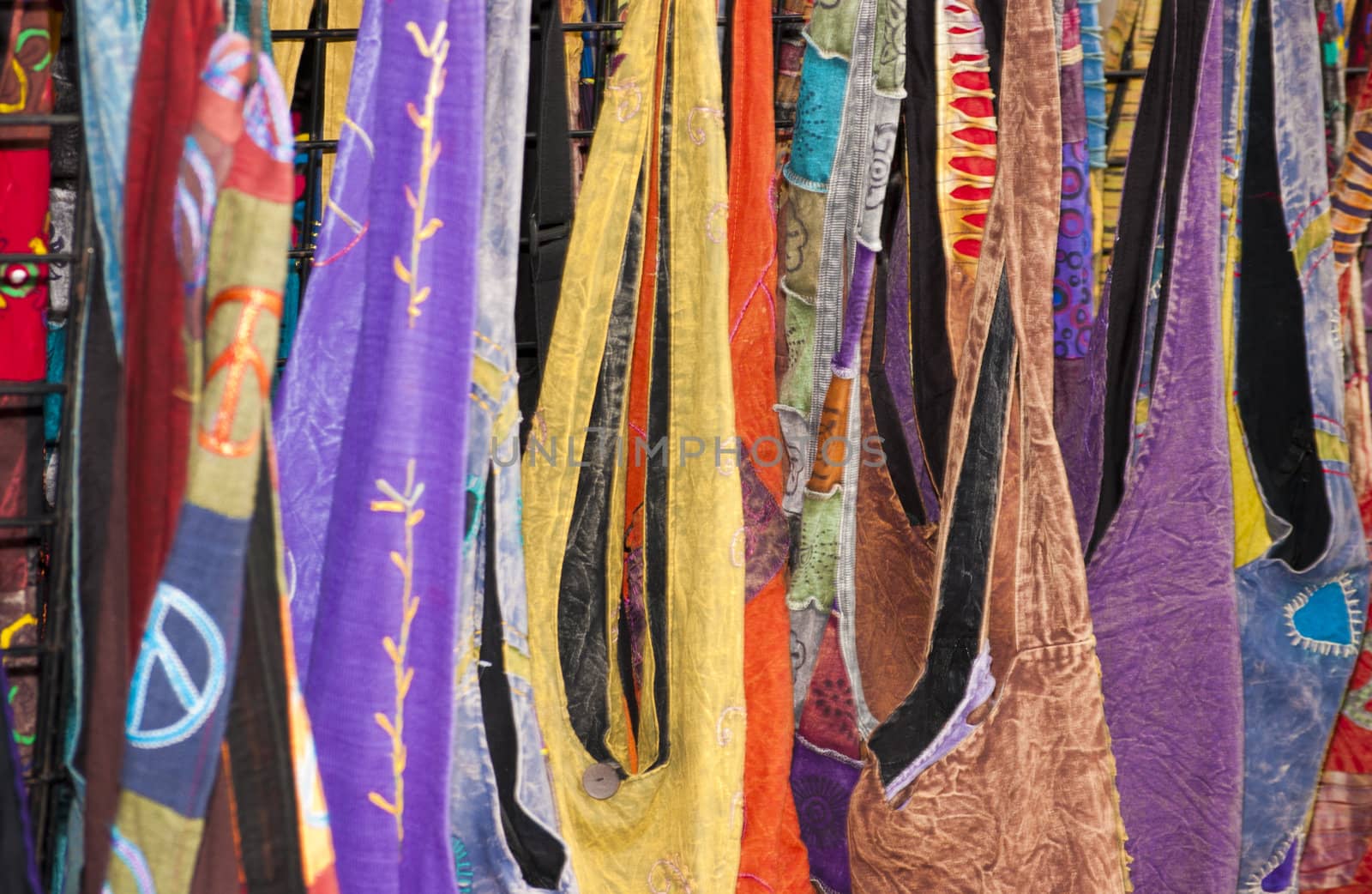 Display of multicolored purses at a public market