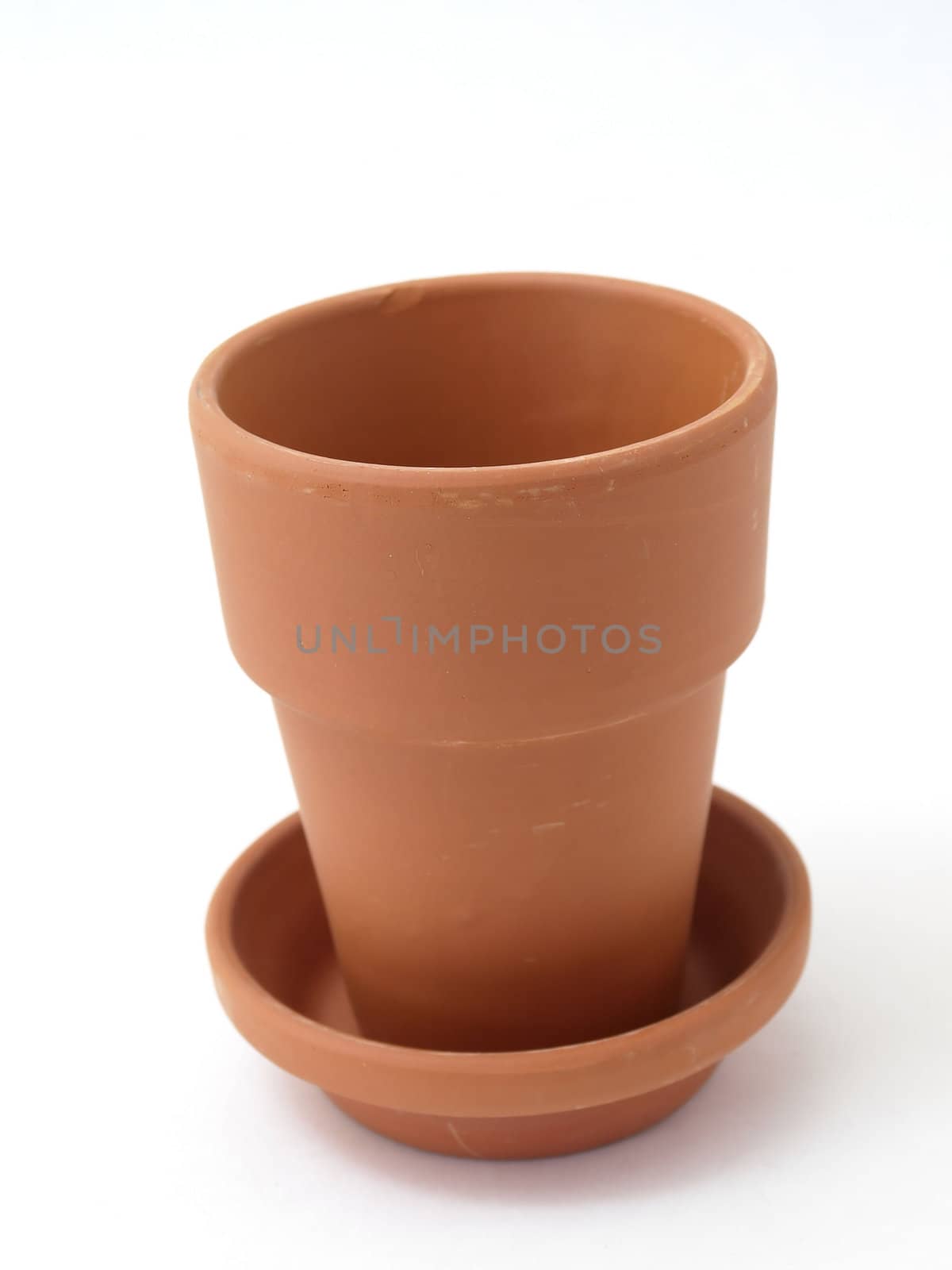 A solitary terra cotta pot studio isolated on a white background.