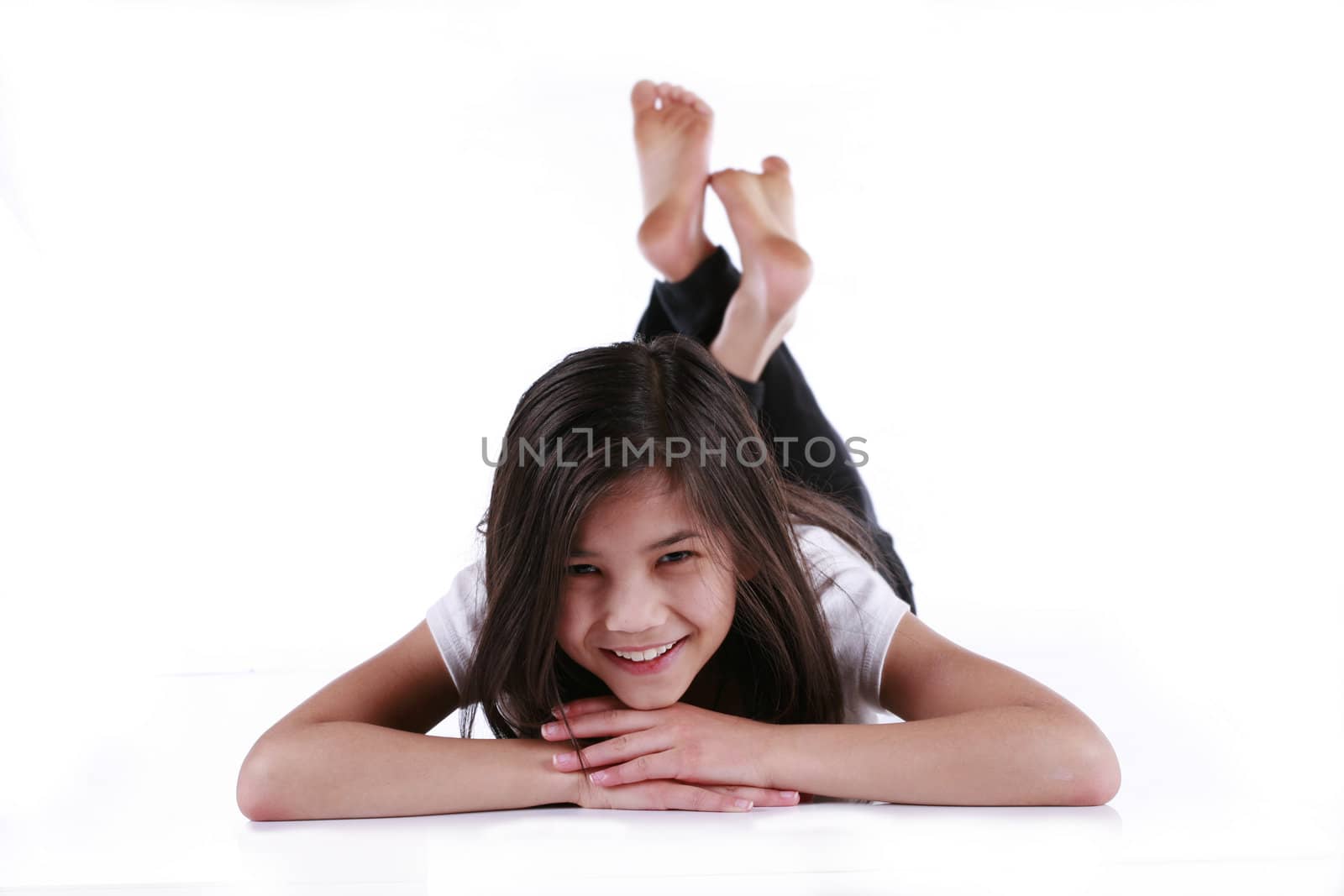 Beautiful ten year old girl relaxing on floor. Scandinavian - Thai background