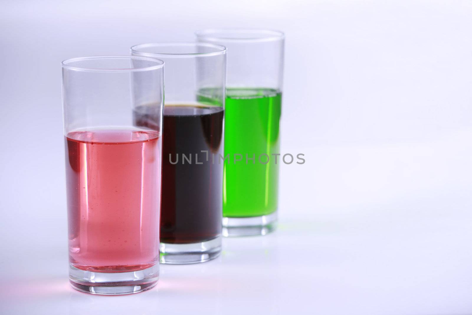 Three glasses with colorful drinks by jarenwicklund