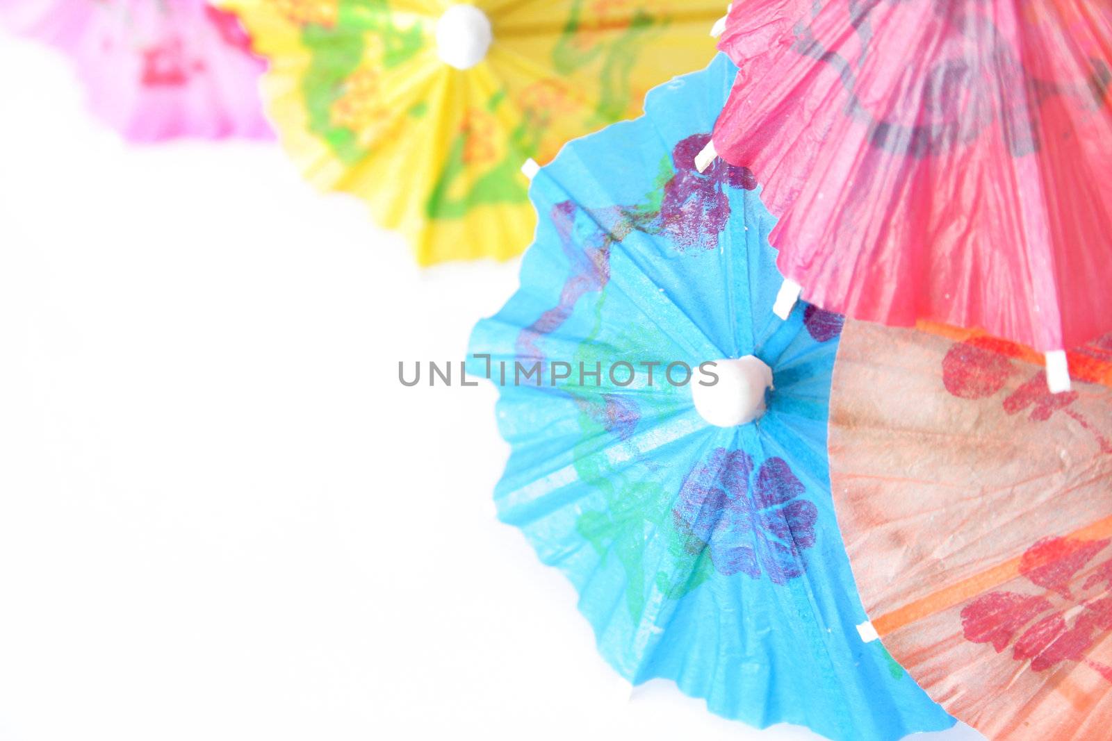 Cocktail umbrellas isolated on white.  Use a shallow depth of field and selective focus.