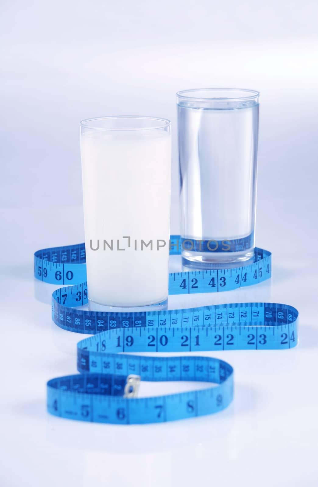 Glass of water and milk, healthy drinks concept on blue tone background