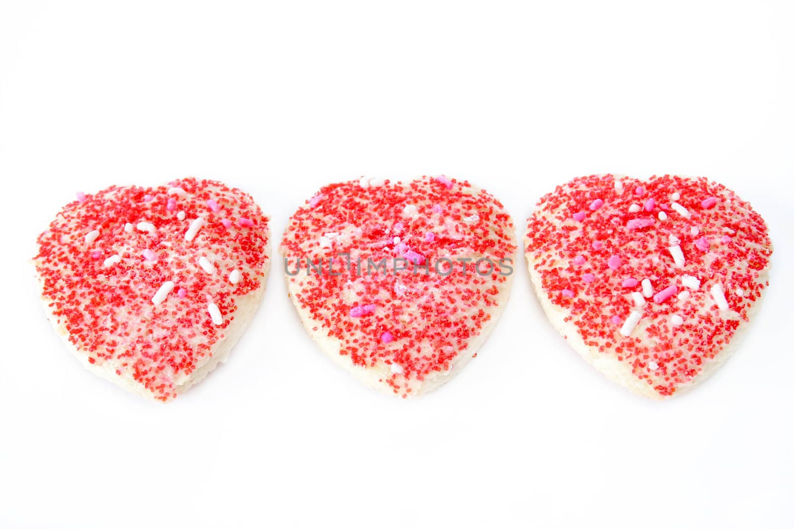 Three heart shaped cookies isolated on a white background.