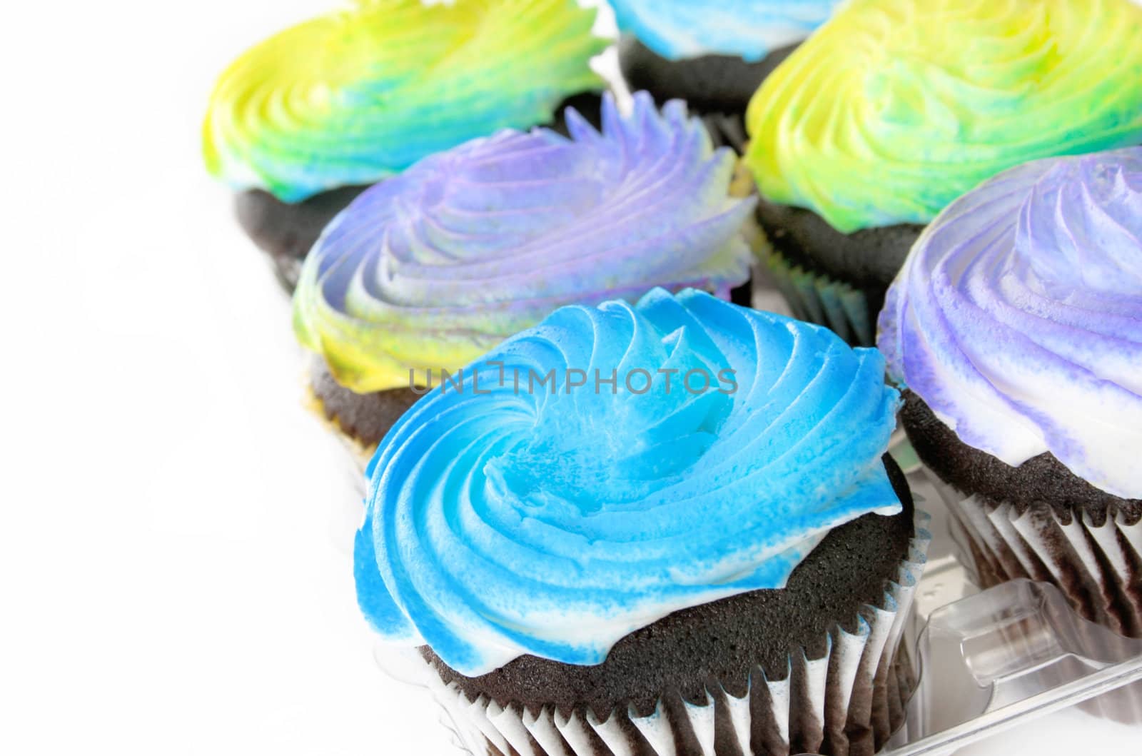 Beautifully colored cupcakes isolated on a white background. 