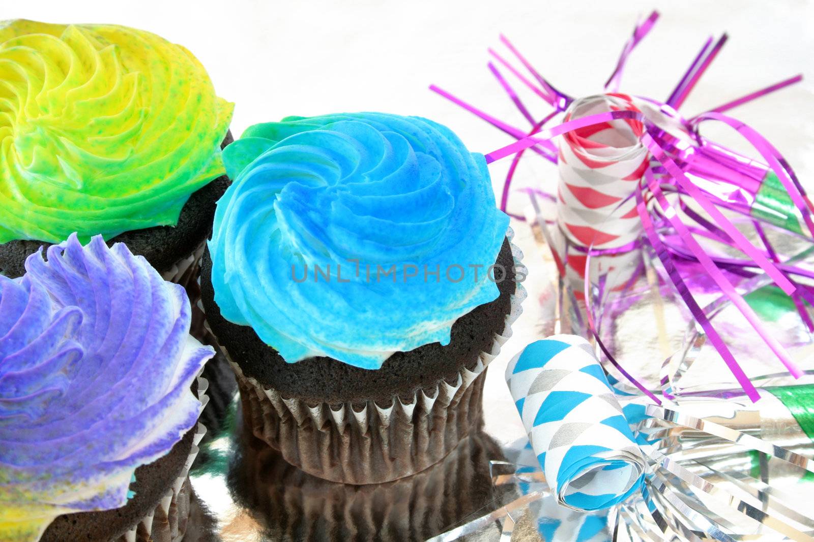 Colorful cupcakes with party favors.