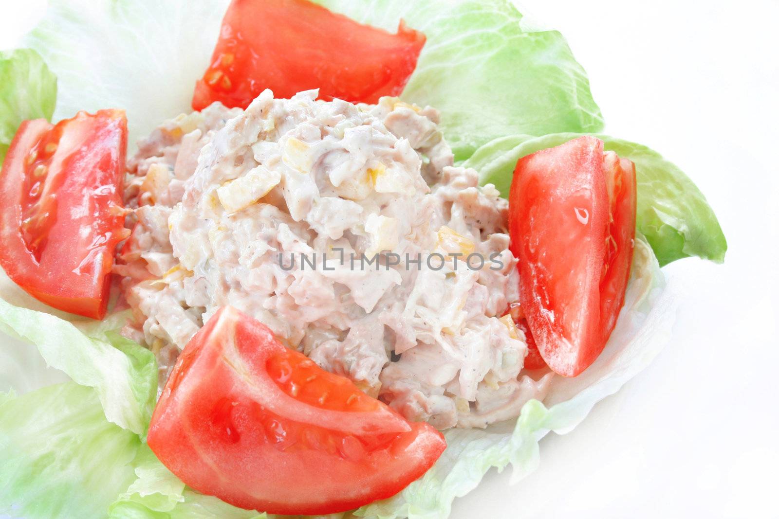 Homemade chicken salad on a bed of lettuce.