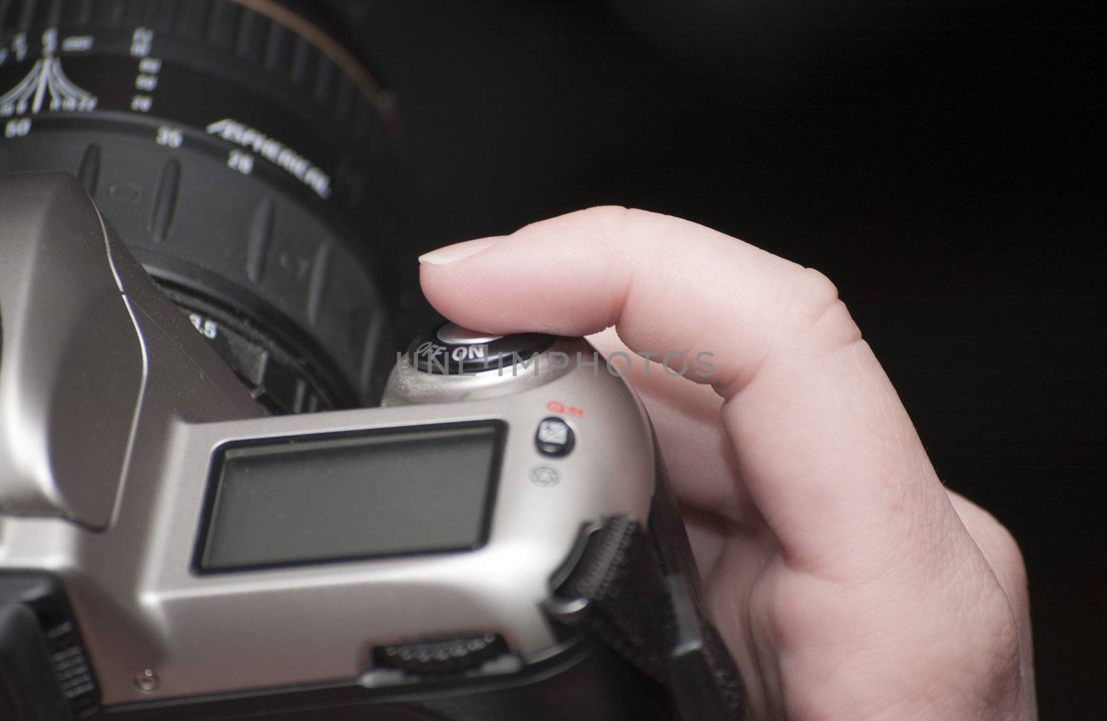 Female finger on shutter button