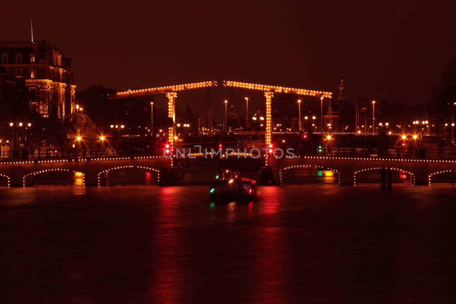 Thiny bridge in Amsterdam by night in the Netherlands