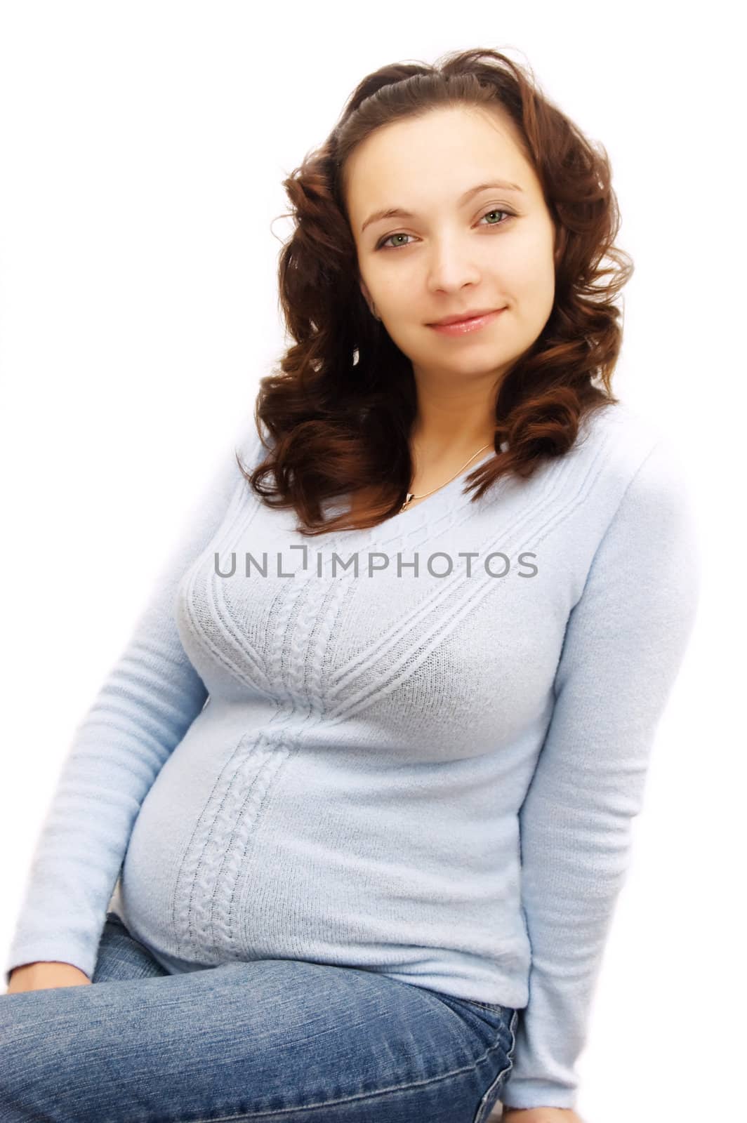 Smiling pregnant woman in blue over white