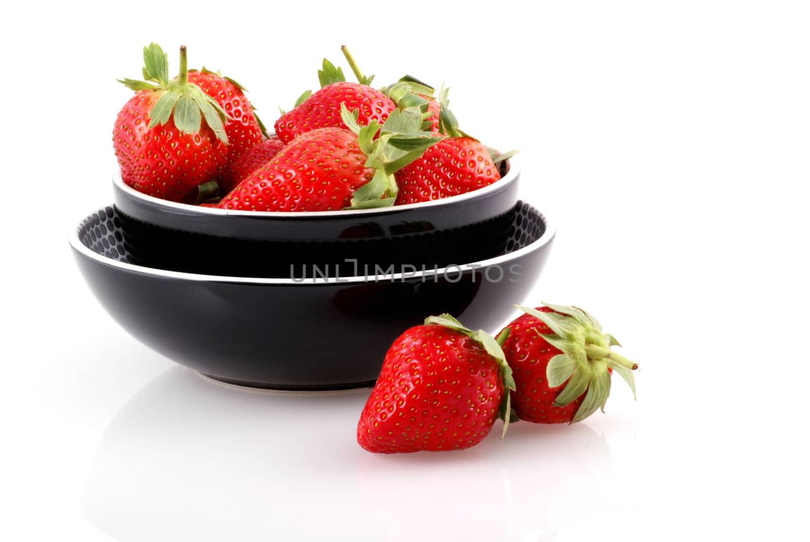 Bowl full of strawberries isolated on white.
