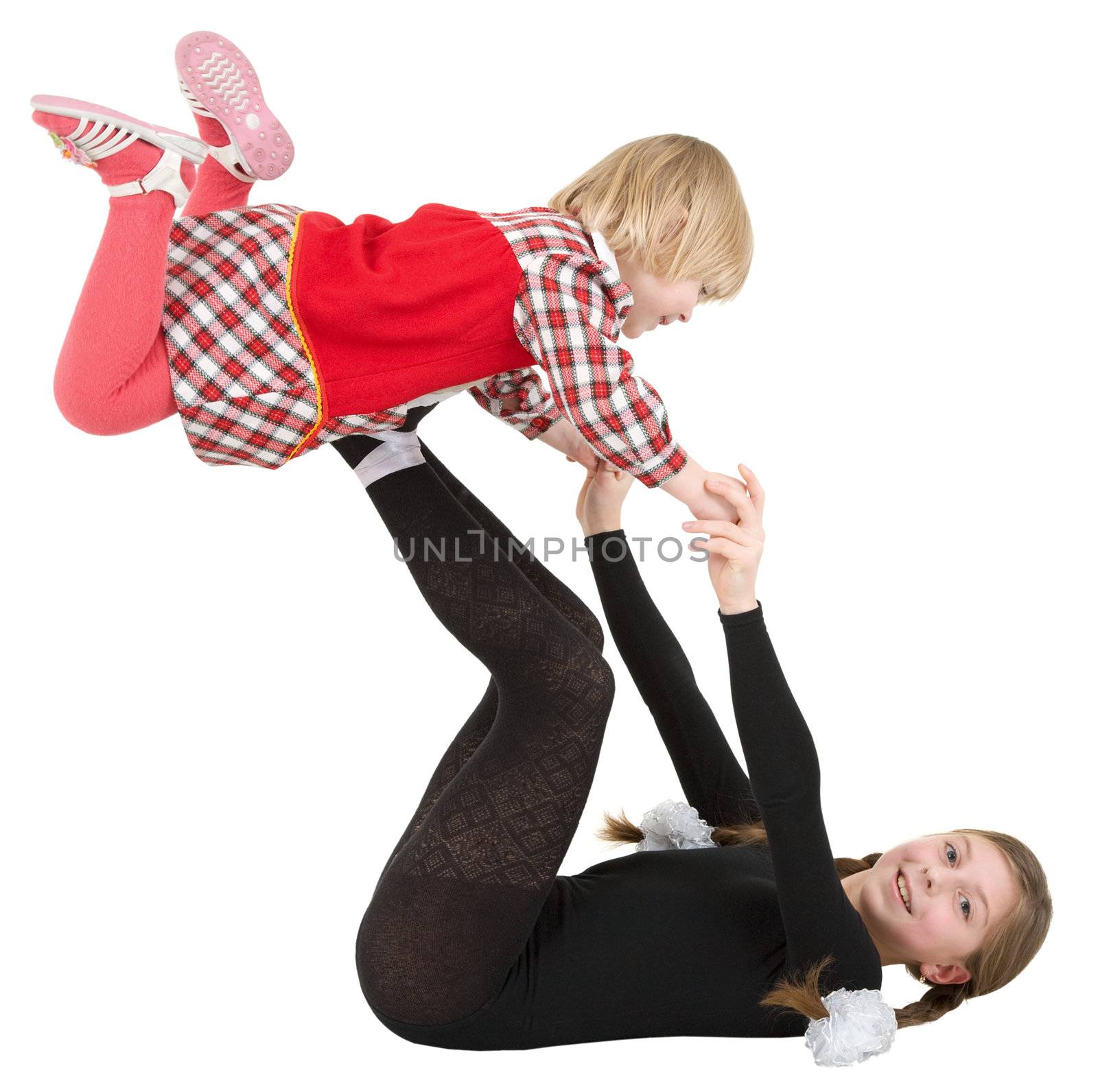 Two little acrobat girls on the white background