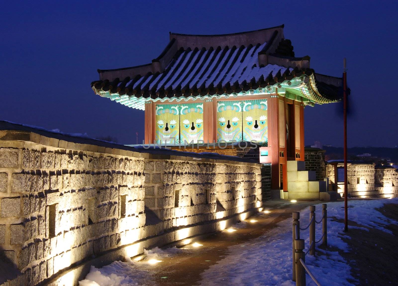 A sentry post on Hwaseong Fortress lit up at night. Hwaseong was constructed for King Jeongjo in 1796 during the Joseon dynasty. It is now a UNESCO World Heritage site. Suwon City, South Korea.