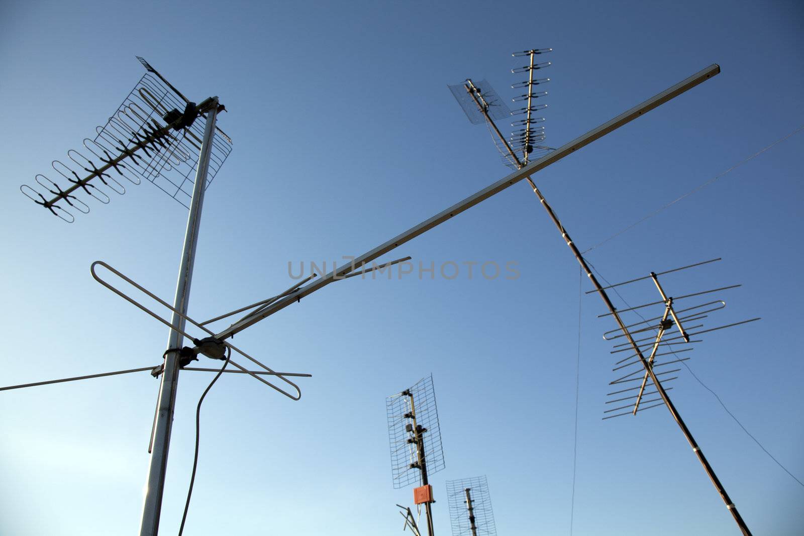 Home TV antennas mounted on a roof.