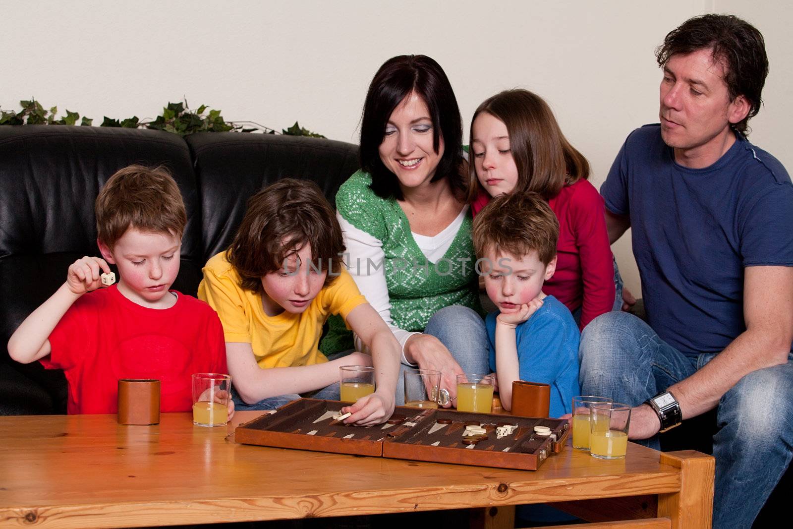 Big family is playing a boardgame in the livingroom