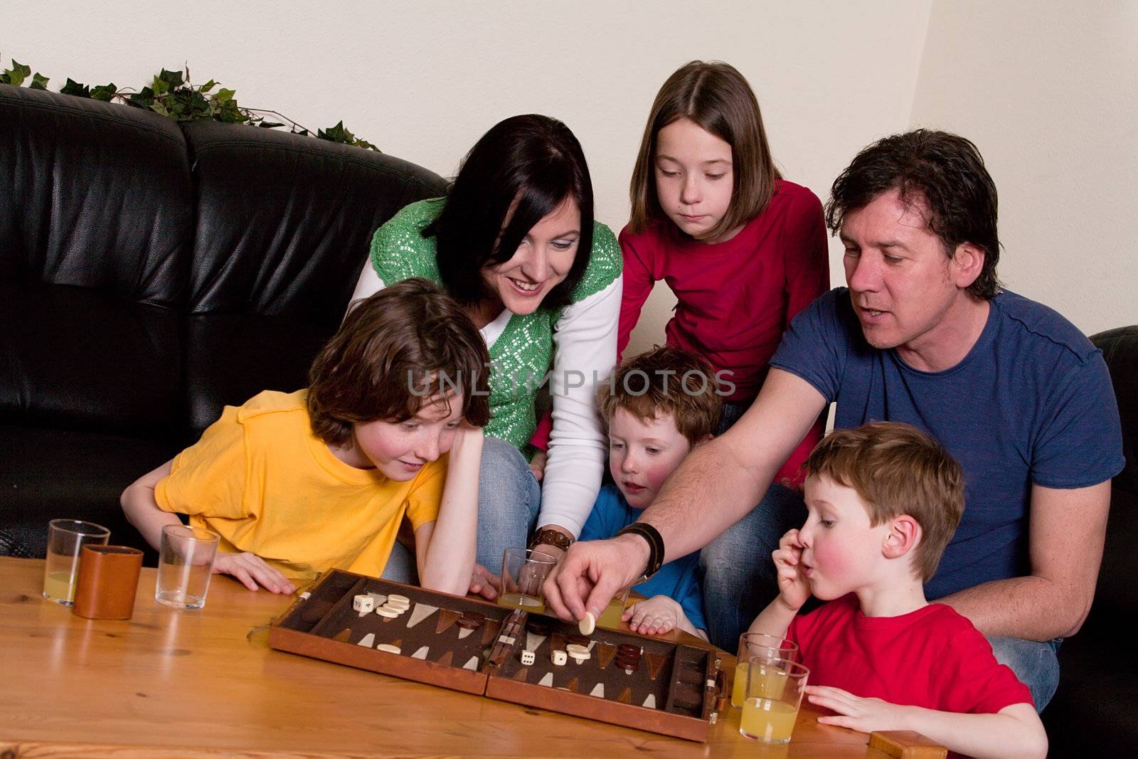 Big family is playing a boardgame in the livingroom