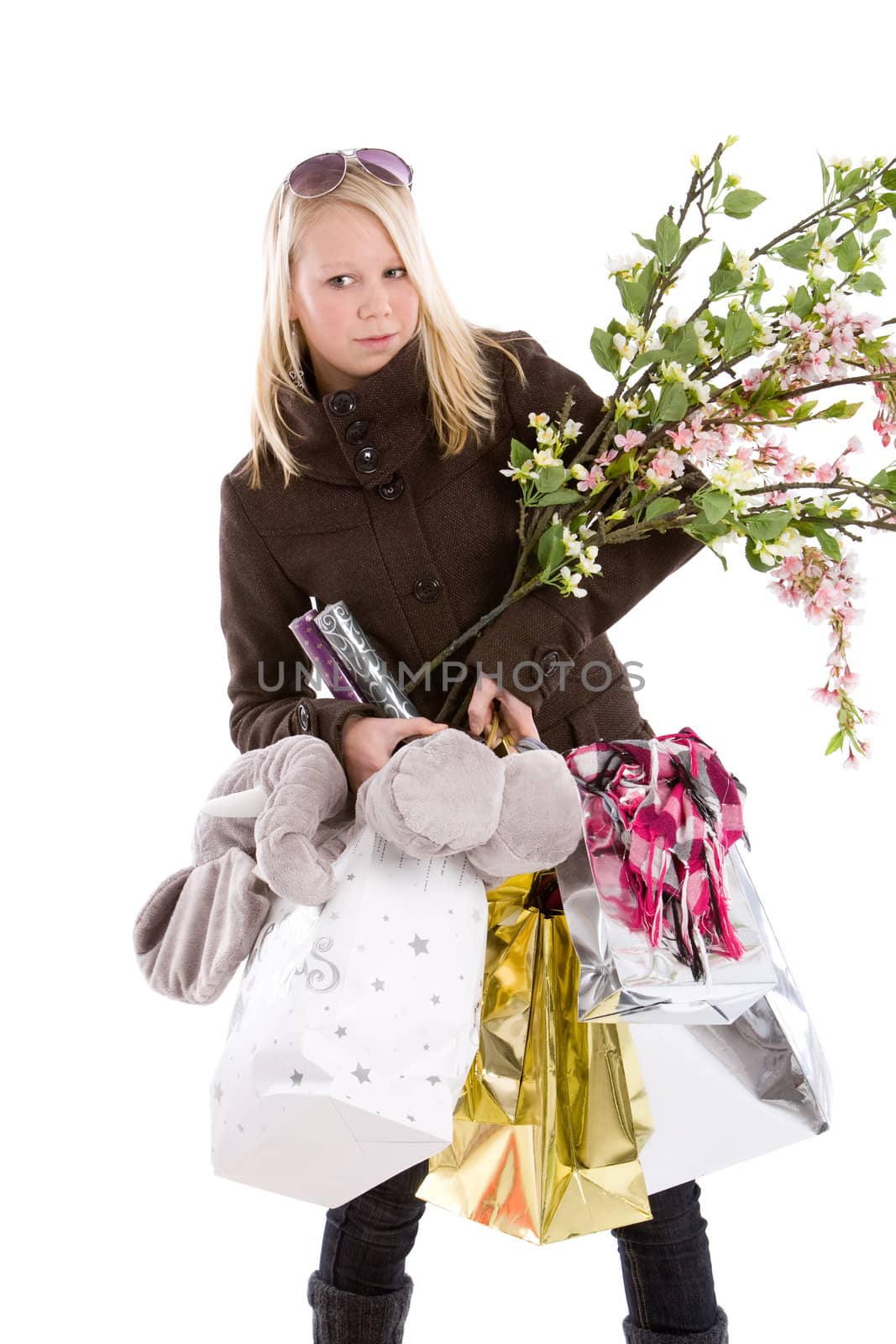 Cute young teenage girl struggling with her shopping bags