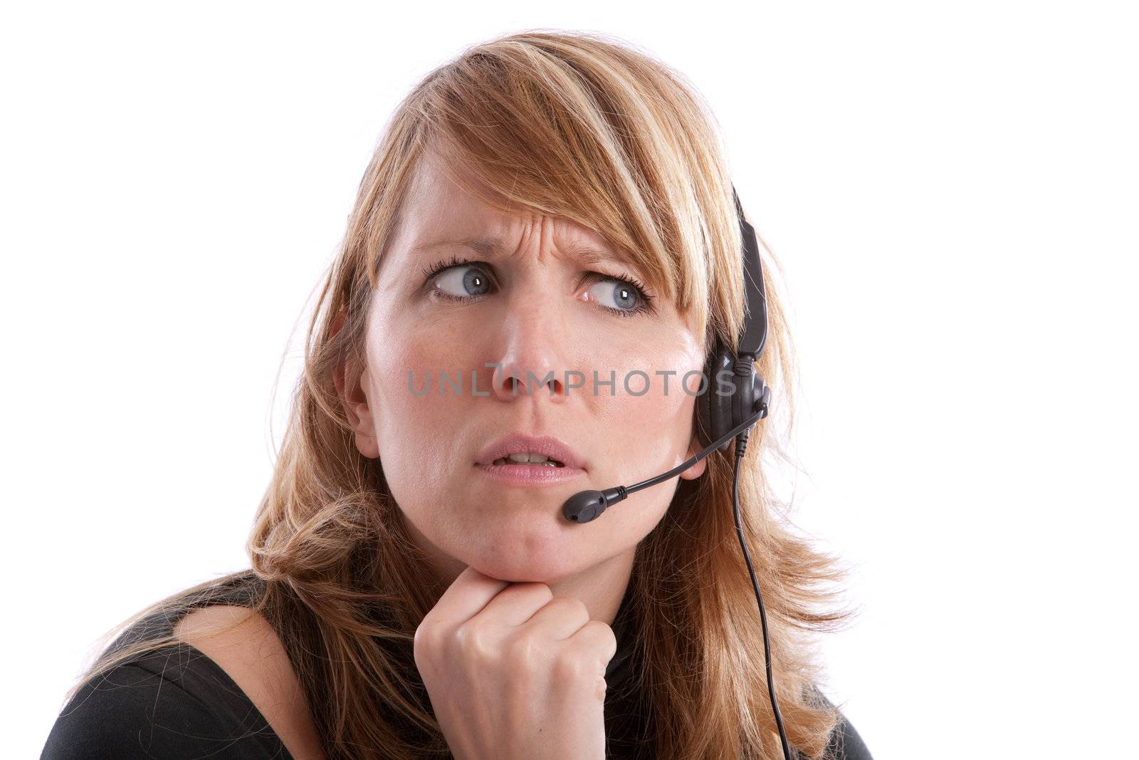Young pretty receptionist looking very irritated with headset on white background