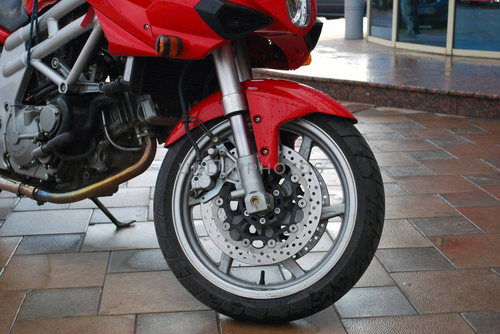 Beautiful red sport motorcycle wet after the rain