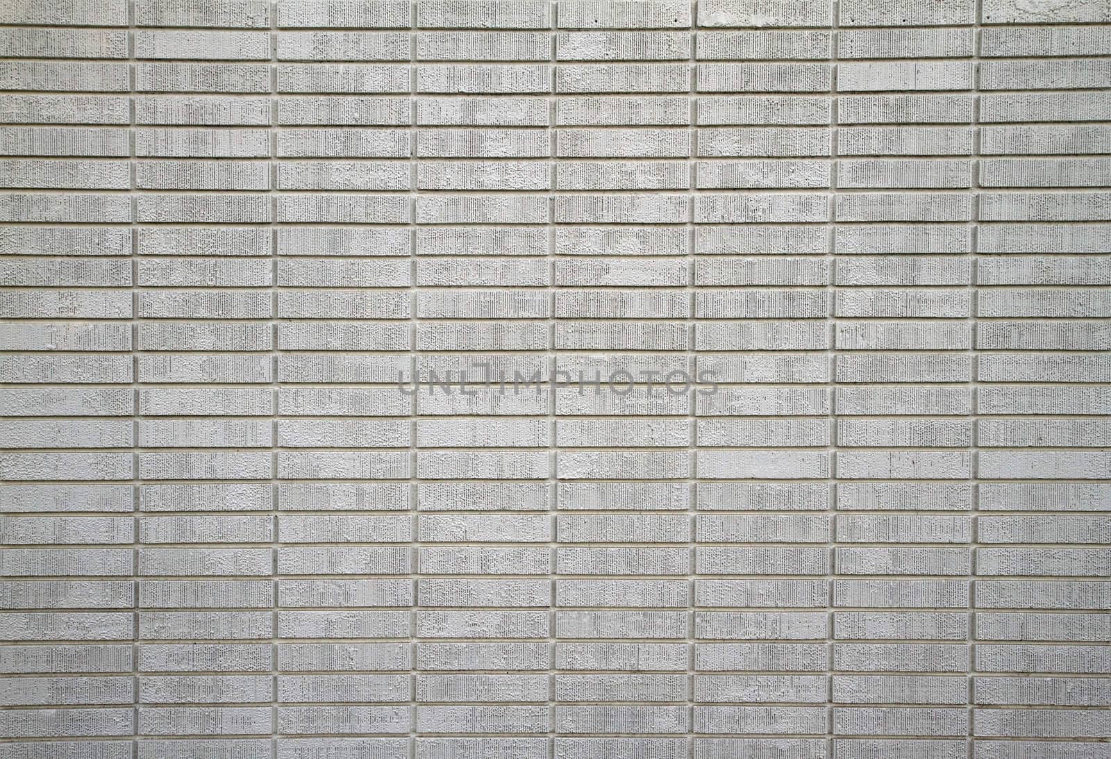 Large wall of white painted bricks taken from distance