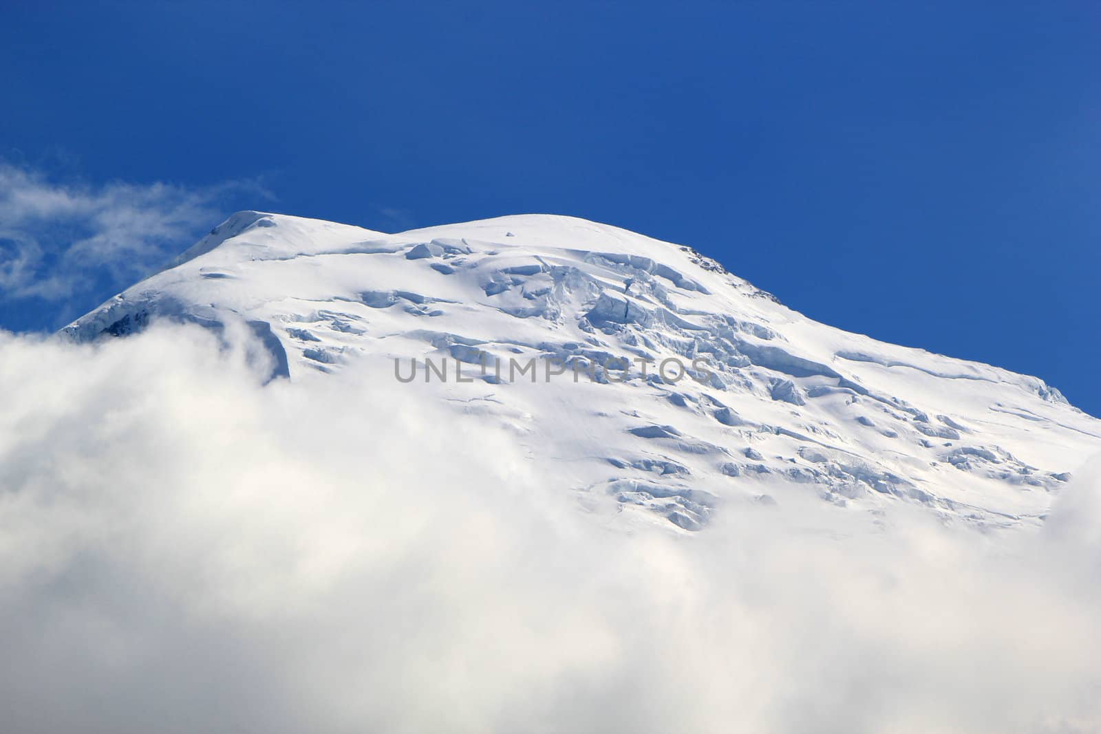 Beautiful snowy top of a mountain in the Alps by Elenaphotos21