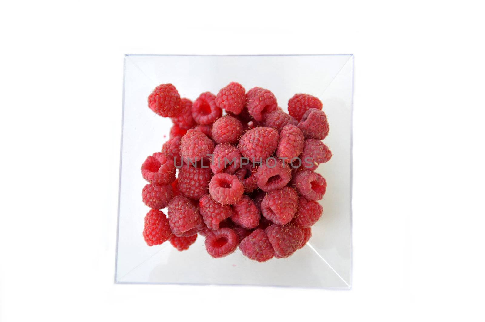 Raspberries on a white background by cynoclub