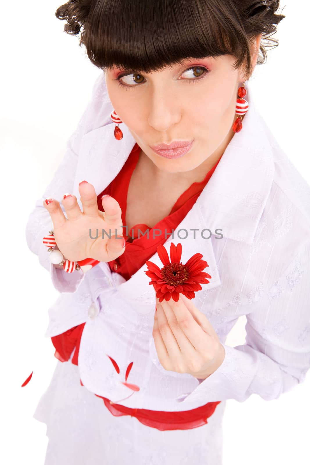 Young cheerful woman guessing her fate by tearing petals off