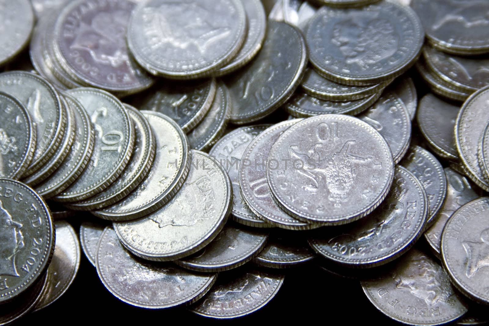 Untidy heap of silver British coins piled up