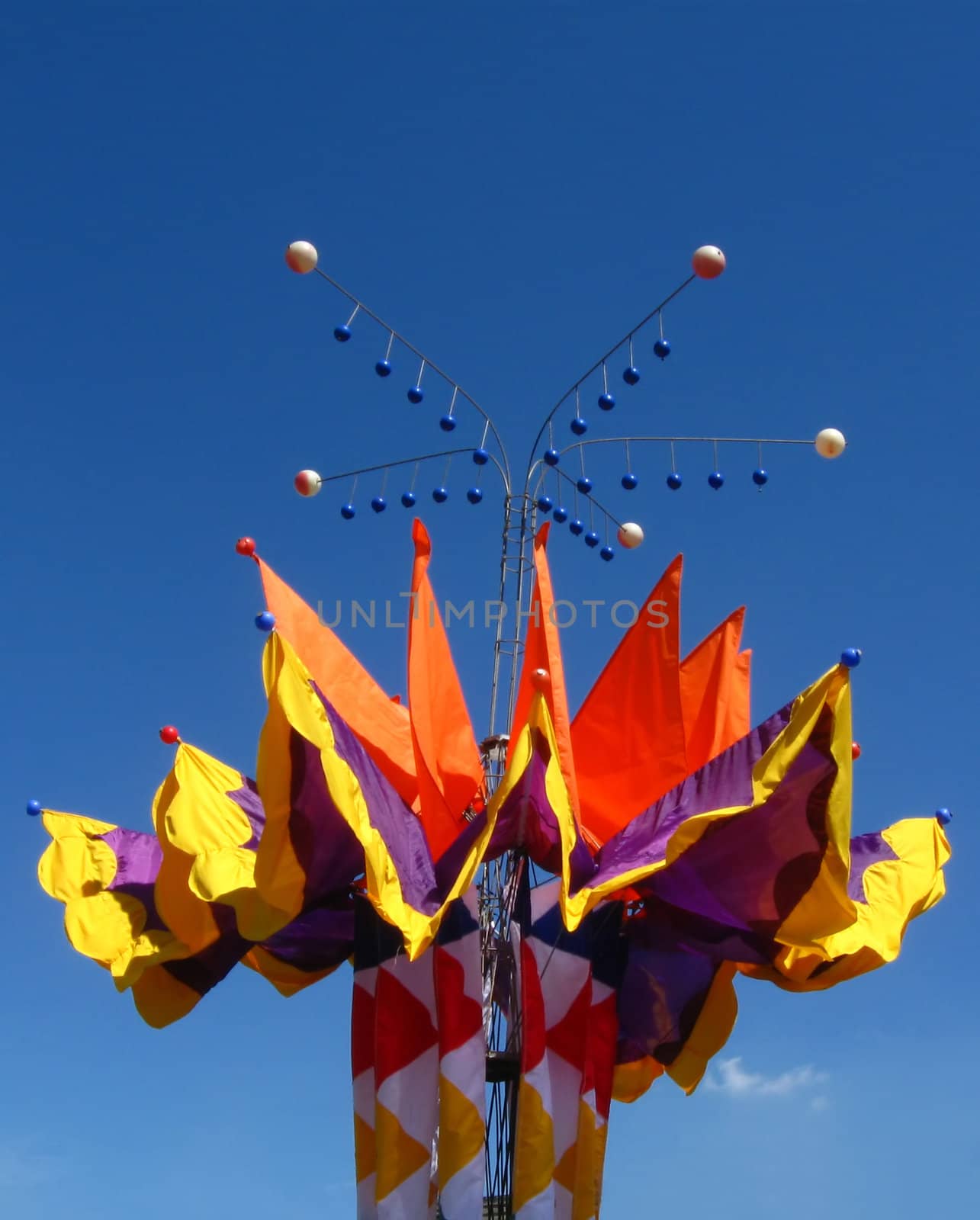  colorful flags  and small metallic  balls on blue sky  background