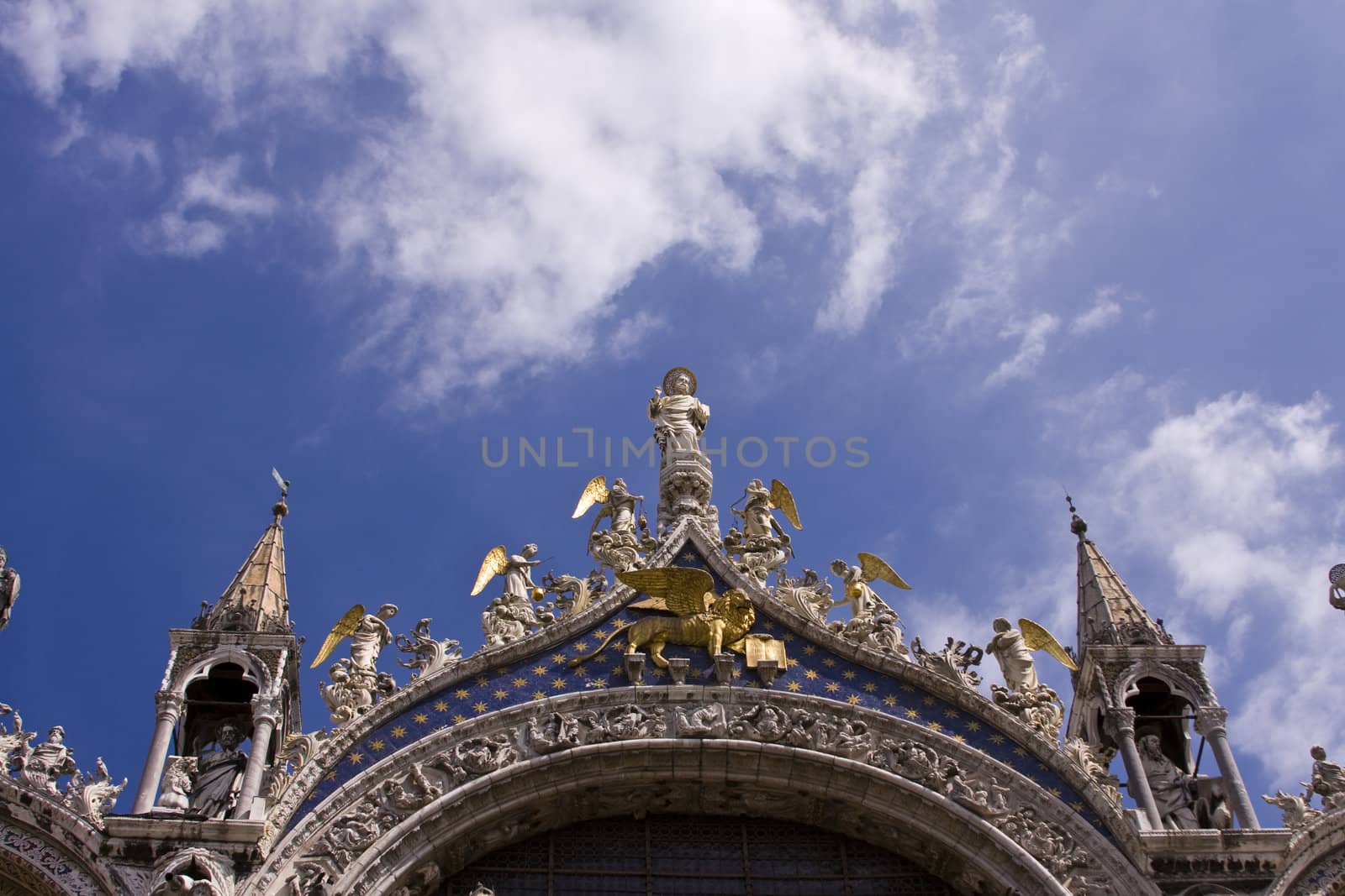 The ornate statues and carvings above the entrance to St Mark`s basilica in Venice Italy
