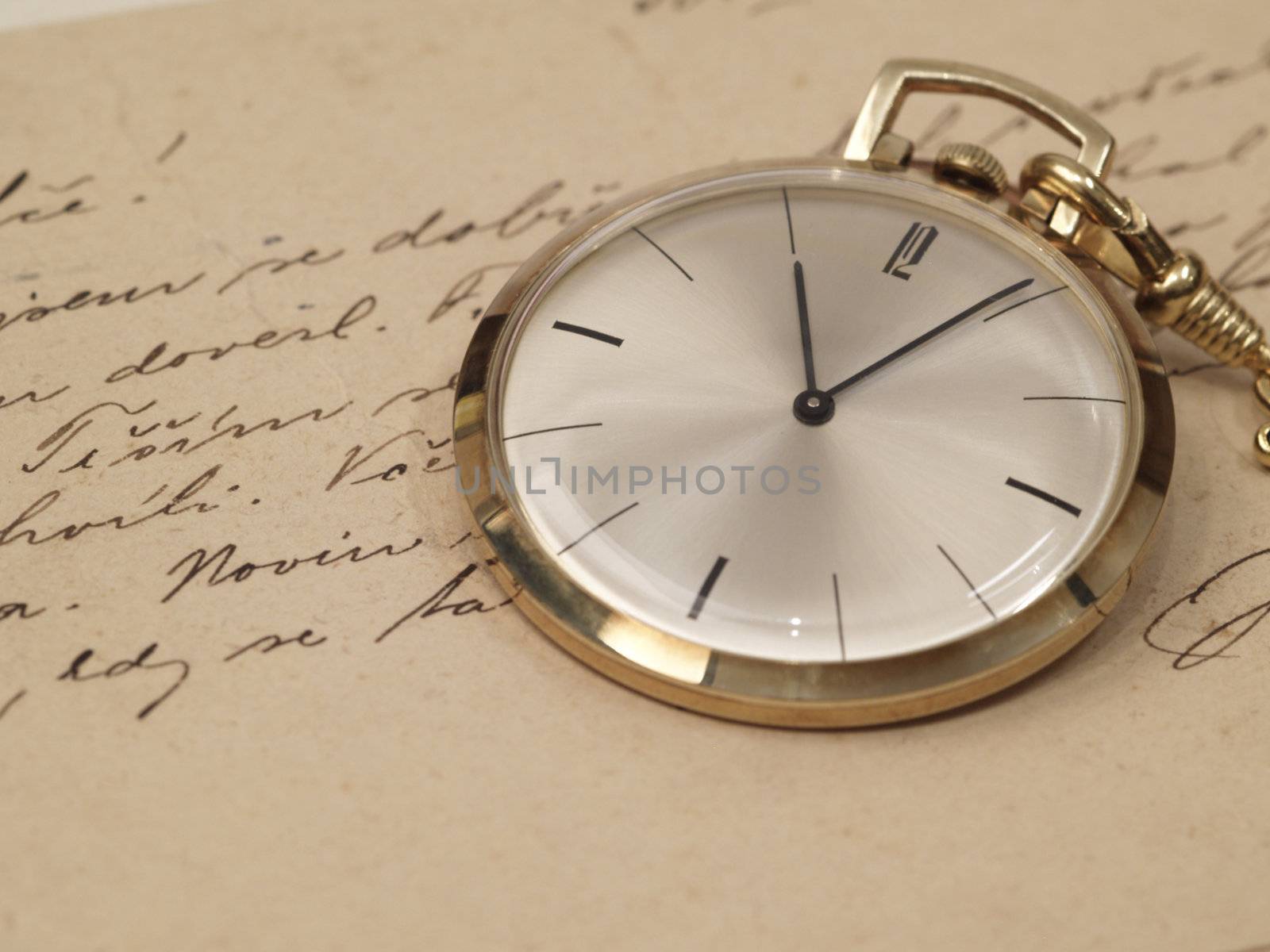 pocket watch over old postcards